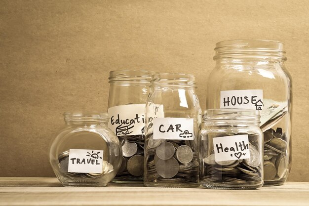 Close-up of glass of jar wit coins on table