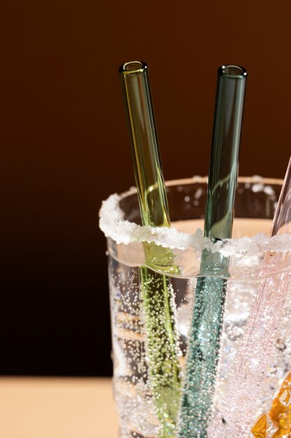 Close-up of glass straws in transparent fizzy liquid