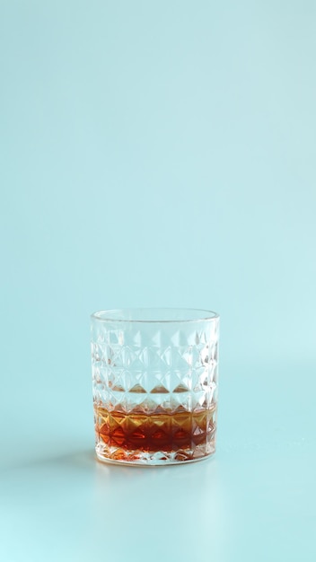 Close up of a glass whiskey served with beautiful glass and flat background