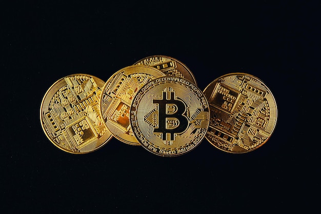 Close up of gold bitcoin arrange on black background with selective focus