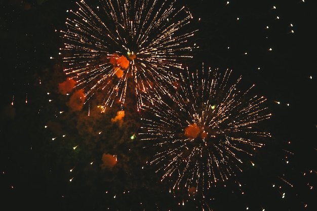 Photo close-up gold festive fireworks on black