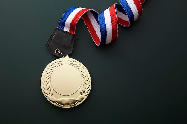Close-up of gold medal against black background