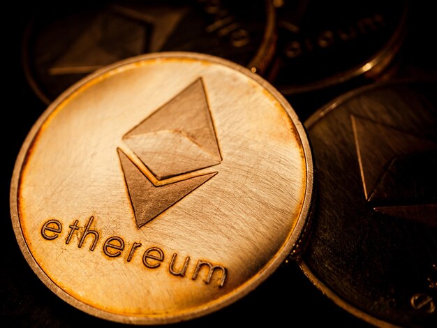 Close up of golden coins with ethereum symbol. Digital currency concept.