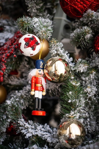 Close up of golden and red balls on christmas tree. Bokeh garlands in the background. New Year concept.