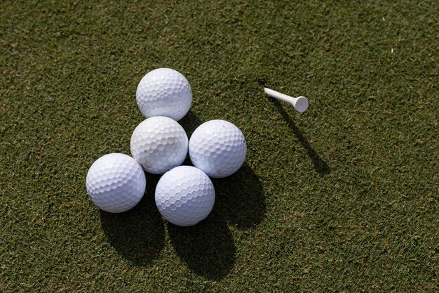 Close up of golf balls and tee