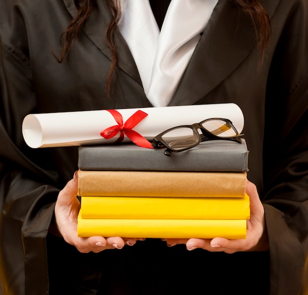 Close-up graduate student holding books