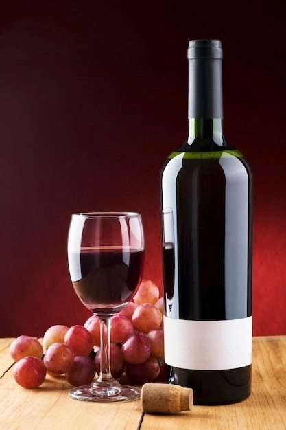 Close-up of grapes with wine bottle on table