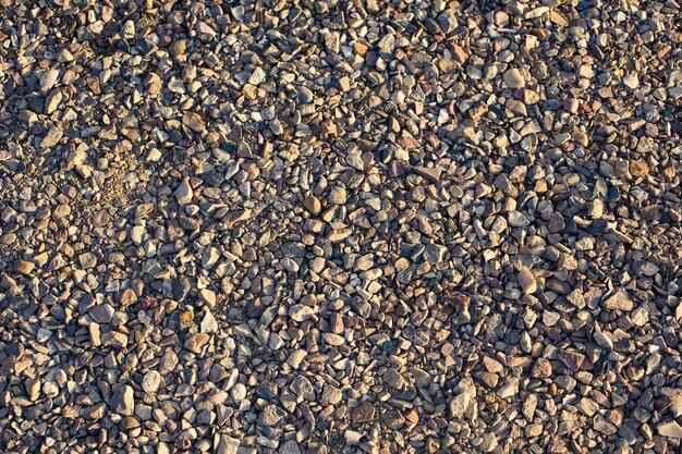 A close up of a gravel surface with a small amount of rocks on it.