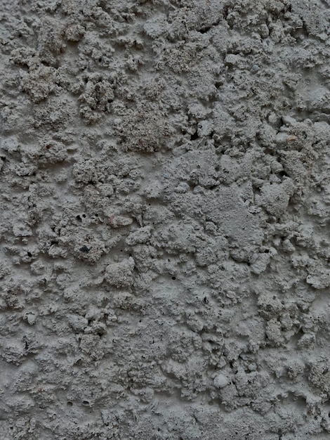 A close up of a gray cement wall with the word concrete on it.
