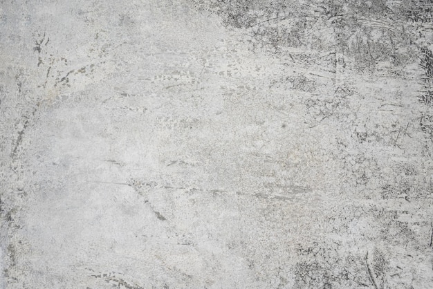 A close up of a gray concrete wall with a white background.