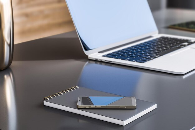 Close up of gray office desktop with smartphone notepad and laptop with blurry mock up place on screen 3D Rendering