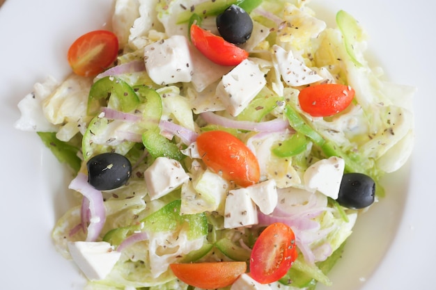 Close up of greek salad in a bowl on table