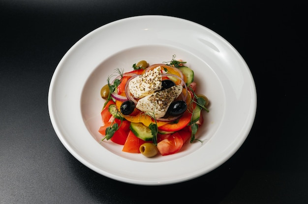 Close up of Greek salad with fresh vegetables feta cheese and olives in a plate Vegetarian healthy