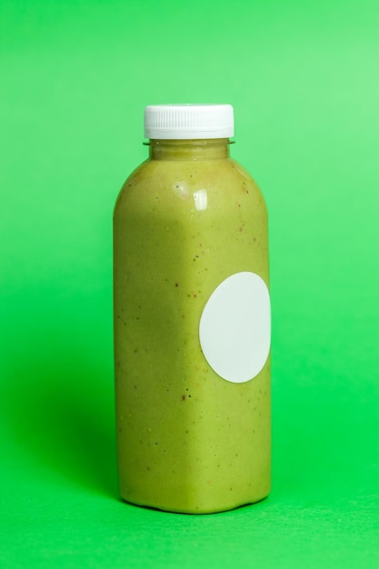 Photo close-up of green bottle against blue background