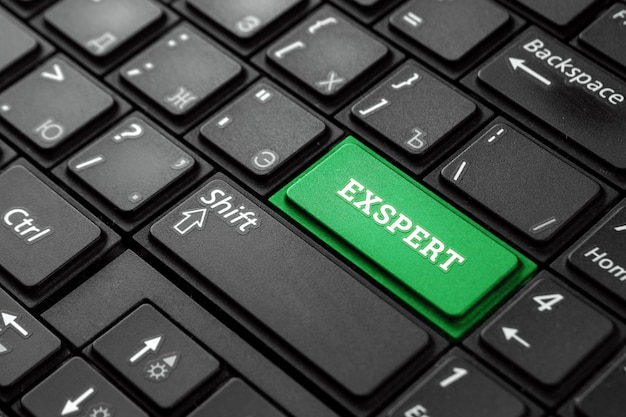 Photo close up green button with the word expert, on a black keyboard. creative background, copy space. concept magic button, professional, connoisseur, professor.