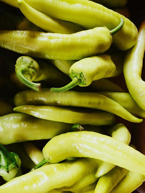 Photo close-up of green chili peppers for sale in market