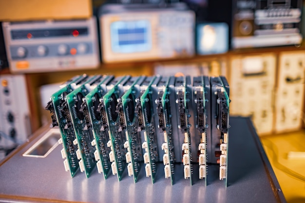 Close-up green embedded microcircuits are stacked in box to prepare for the further in factory for production of equipment