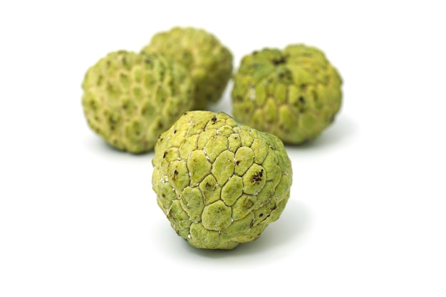 Close-up of green fruit against white background