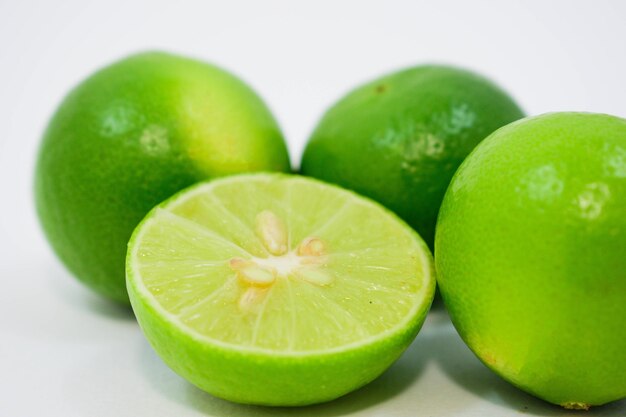 Close-up of green fruits against white background