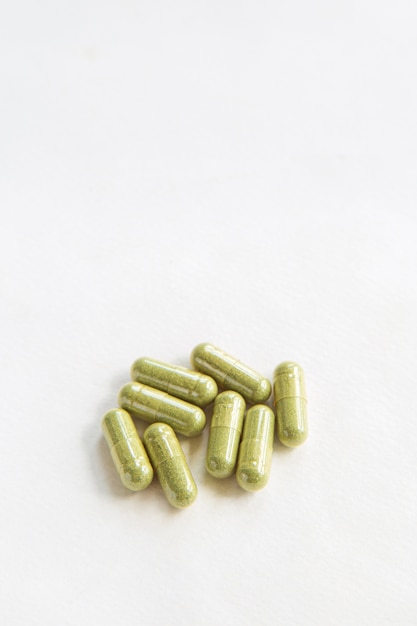 Close up green herbal medicine in capsules from Andrographis paniculata, healthy herbal from natural product,