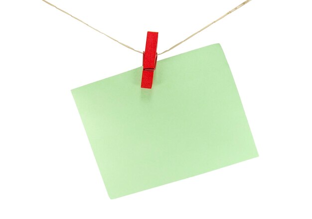 Photo close-up of green paper hanging string against white background