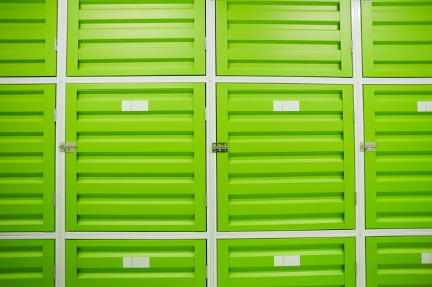 Photo close-up of green storage boxes in warehouse