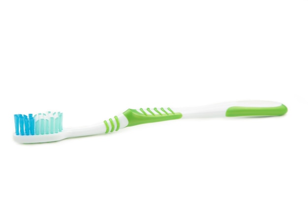 Close up on green toothbrush isolated