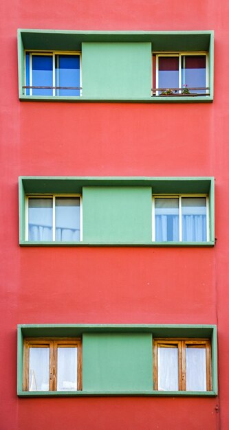Close-up of green window in red house