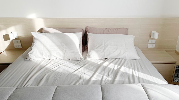 Close up grey bed sheet in bedroom, cozy interior dÃÂ©cor with earth tone, Bed top view with wooden floor