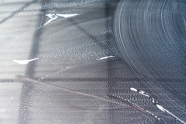 close-up grey car with washing foam