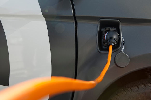 Close up of a grey electric car charger sport and modern design\
under the sun light