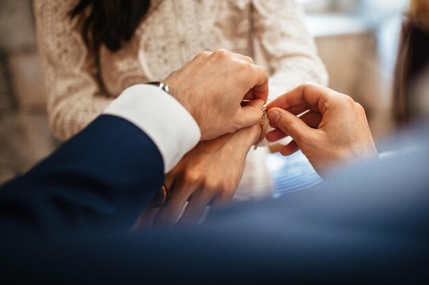 Close up of groom giving his bride bracelet as symbol of his love on their wedding day