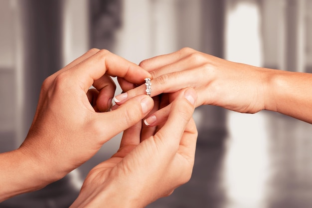 Close up Groom Putting the Wedding Ring on bride