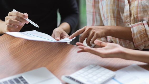 Close-up group of business team discussing their financial profit in meeting room