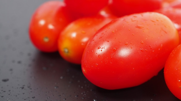 Close up group of Cherry Tomatoes on black background.