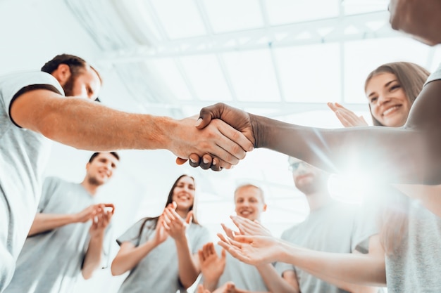 Close up. a group of students applauding two opponents during a business briefing. business and education