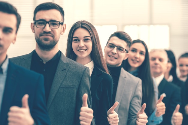 Close up. a group of young entrepreneurs standing together and giving a thumbs up