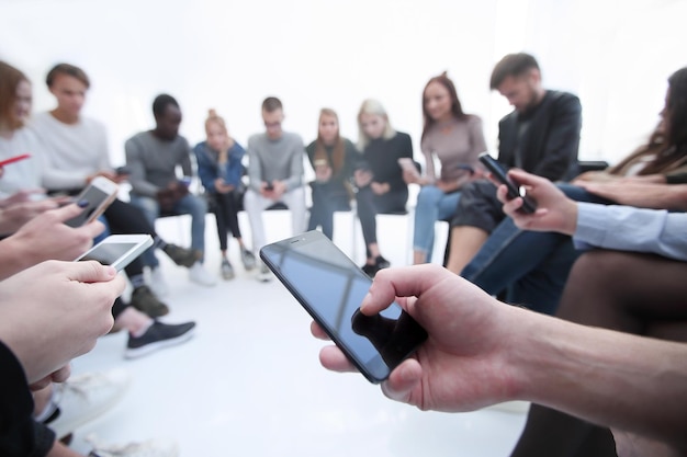 Close up groups of young people with smartphones