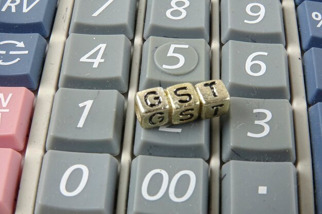 Photo close-up of gst letter blocks on calculator