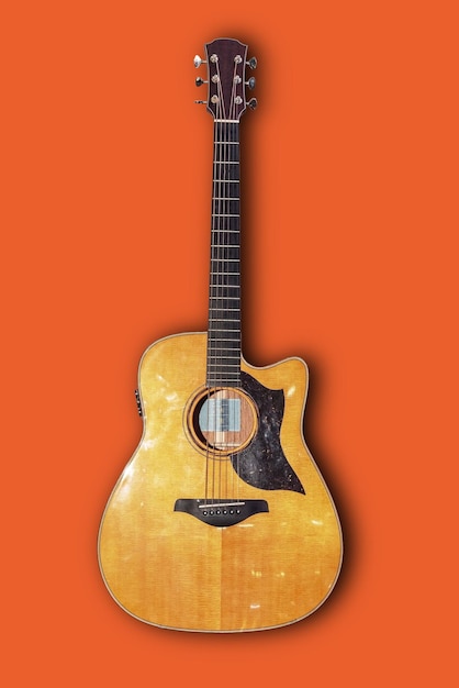 Close-up of guitar against orange background