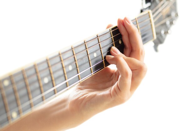 Close up of guitarist hand playing guitar, macro shot. Concept of advertising, hobby, music, festival, entertainment. Person improvising inspired. Copyspace to insert image or text.