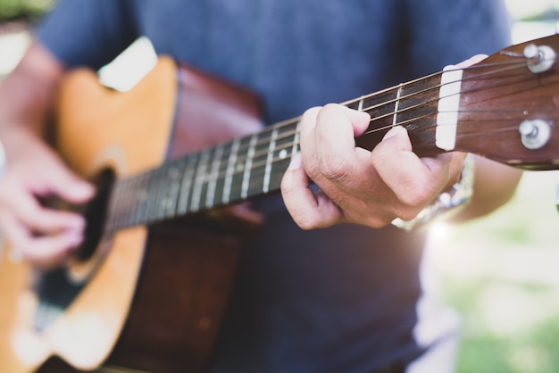 Close up of guitarist hand playing guitar. Musical and instrument concept