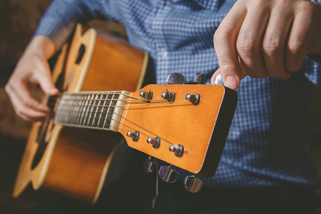 Close up of guitarist hand playing guitar