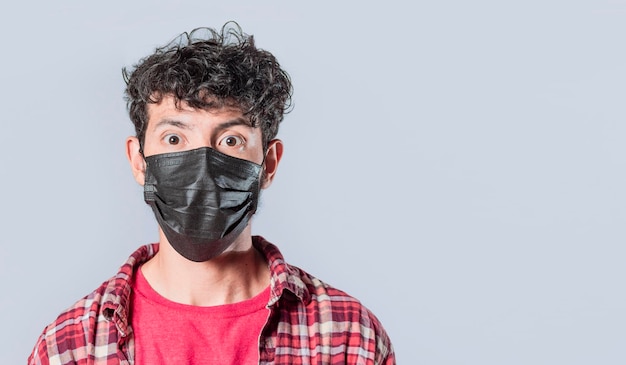 Close up of guy wearing surgical mask on isolated background close up of handsome guy wearing protective mask