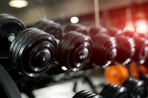 Close up of gym equipment. Heavy barbells standing on a stand.