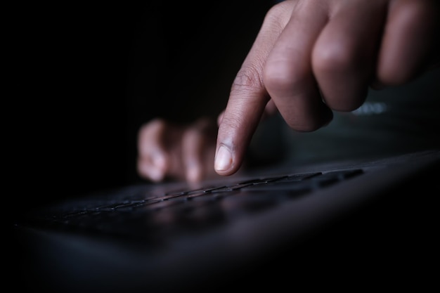 Close up of hacker hand stealing data