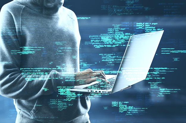 Close up of hacker using laptop with creative coding html language on blurry office interior background Web developer hacking malware and programming concept Double exposure