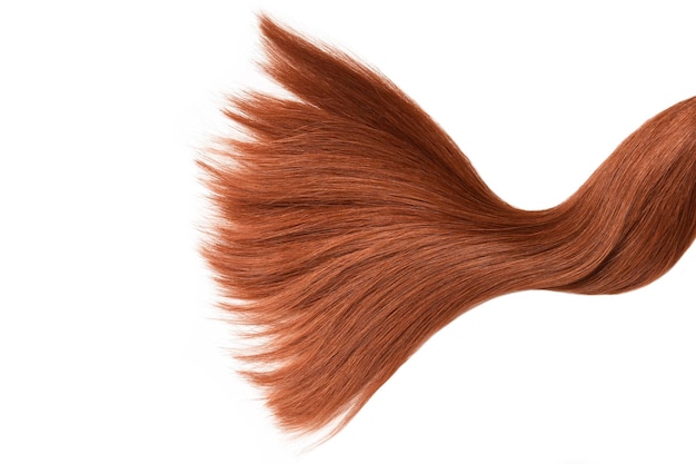 A close up of a hair color with a long section of hair