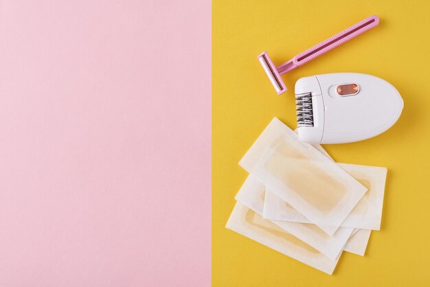 Photo close-up of hair removal equipment on colored background