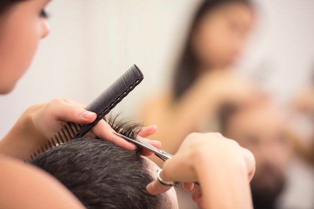 Close-up hairdresser with scissors and comb.